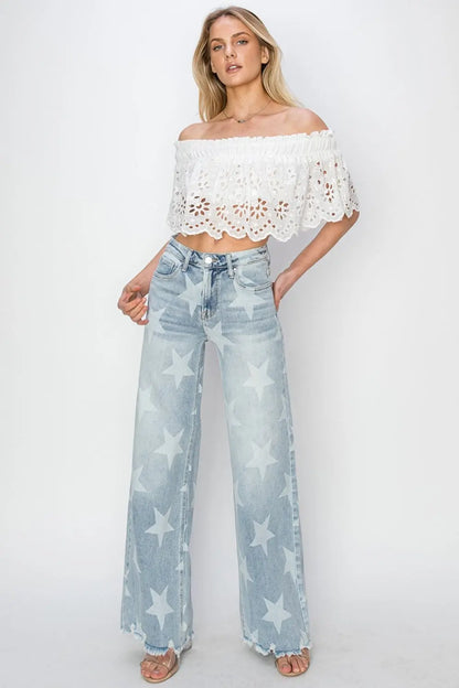 Lady wearing Full Size Raw Hem Star Wide Leg Jeans with trendy star accents, edgy raw hem, and flattering wide-leg fit for bold, stylish looks.