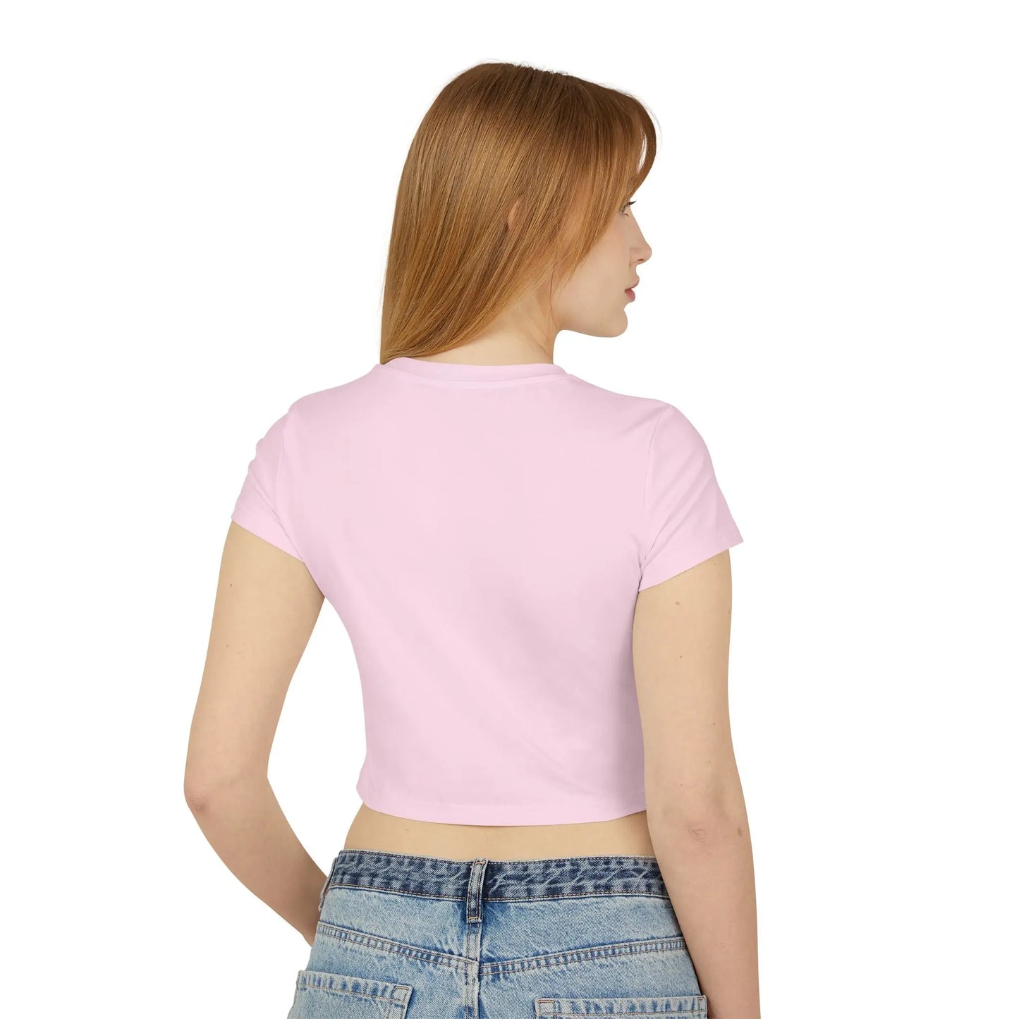 The back view of a lady with long red hair wearing a pink baby tee crop top.