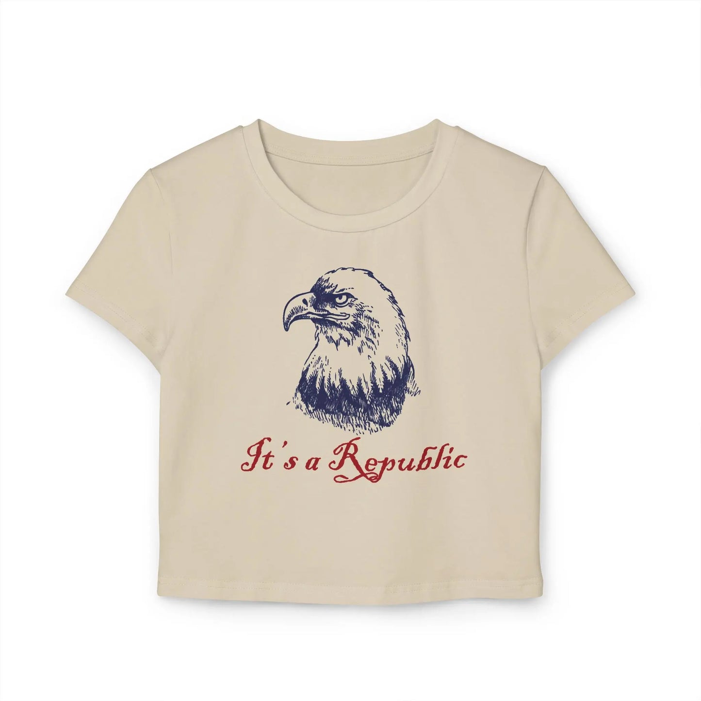 Sand baby tee crop top with eagle design and "It's A Republic" text.