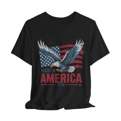 Black eagle and flag design on a t-shirt with the text 'Made in America 1776' symbolizing patriotism and freedom.