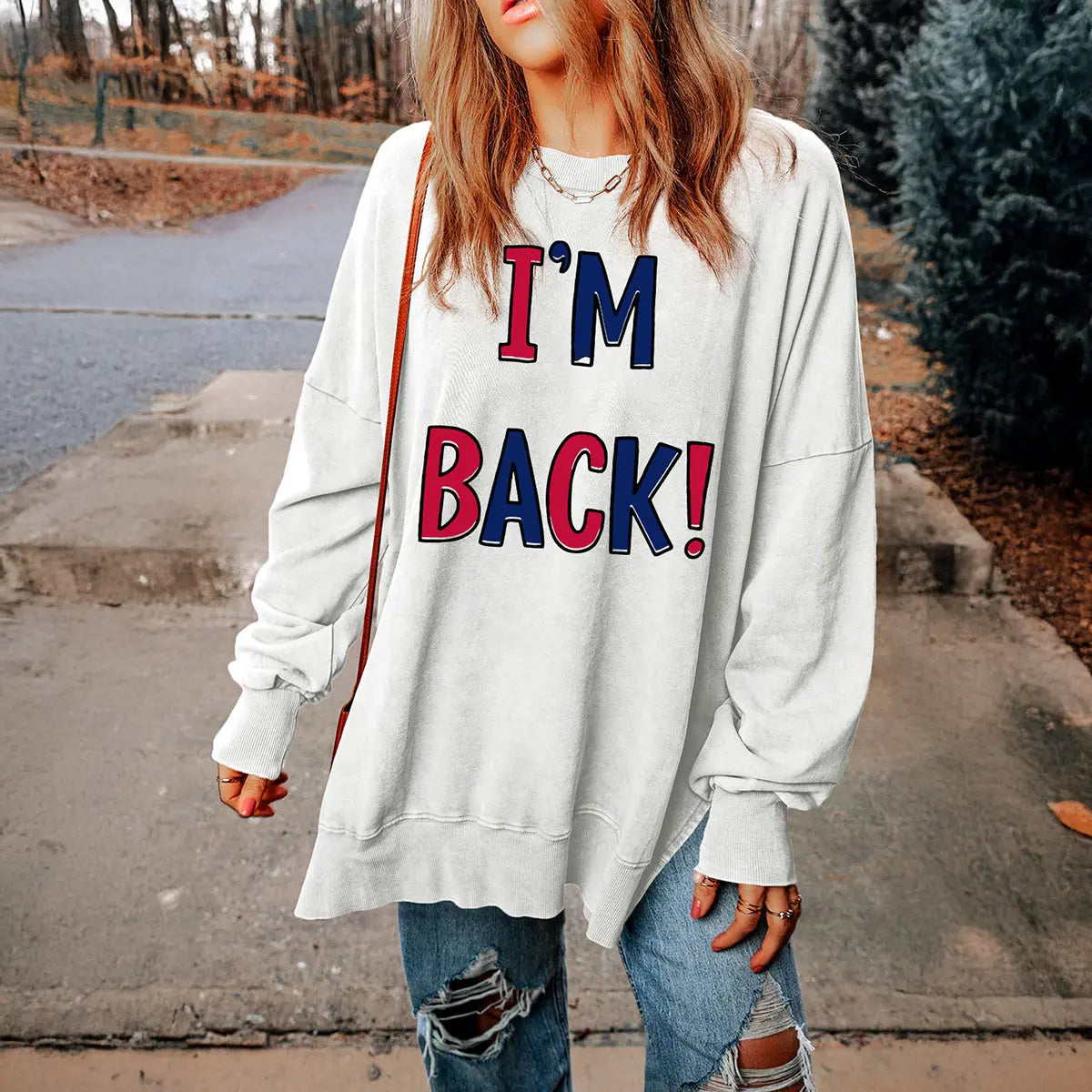 I'M BACK Slit Round Neck Long Sleeve Sweatshirt, bold and stylish design with unique slit detail, perfect for modern casual looks.