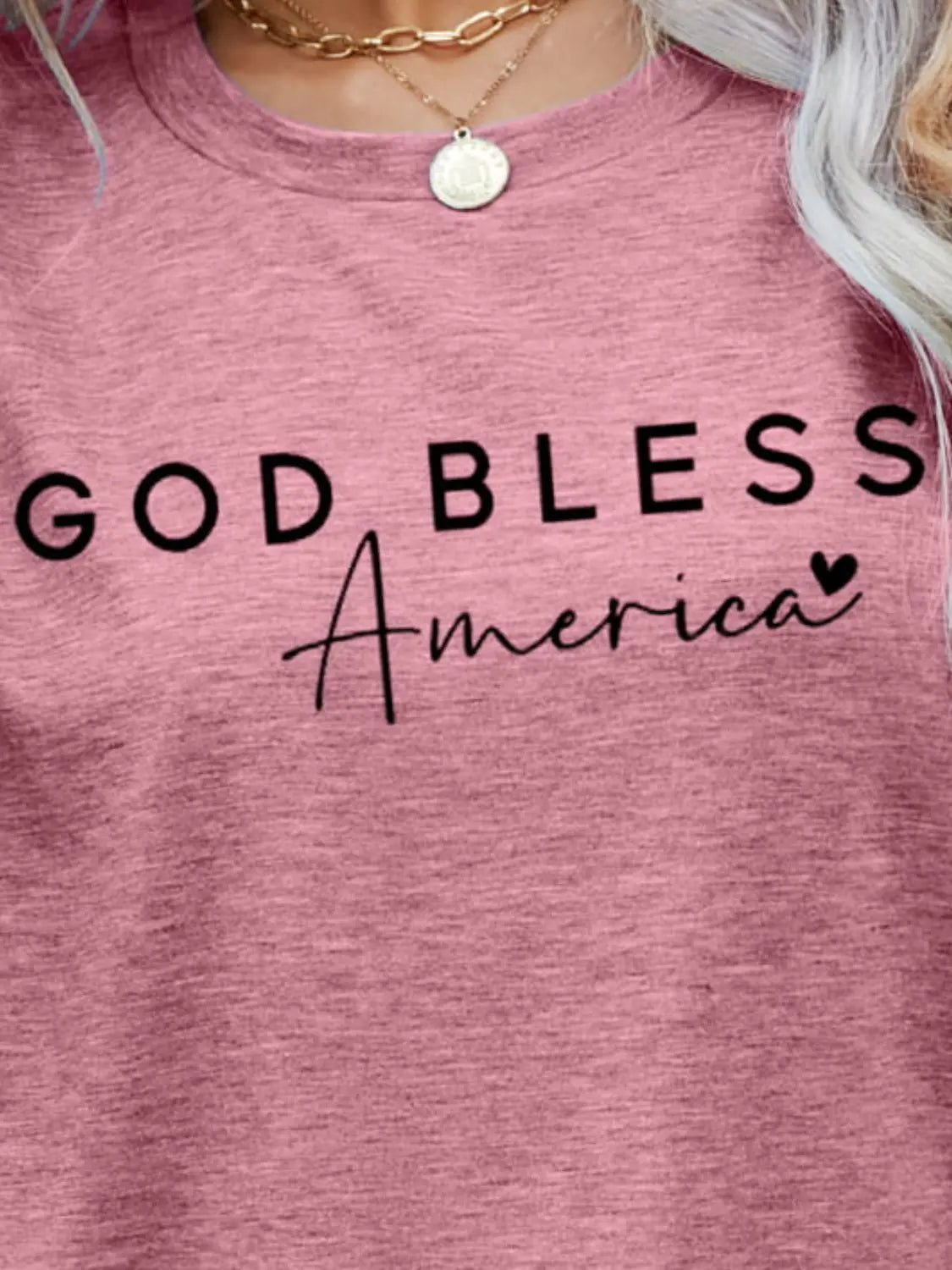 Close up Blush Pink God Bless America Graphic Short Sleeve Tee with bold patriotic design, breathable fabric, and a comfortable fit for stylish everyday wear.