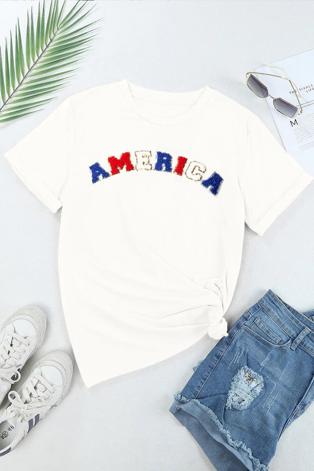 Flat lay AMERICA Round Neck Short Sleeve T-Shirt for women, a bold, stylish patriotic tee perfect for everyday wear and celebrating American pride.