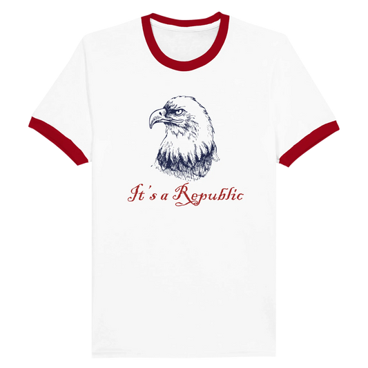 White shirt with red trim on neck and short sleeve cuffs with an eagle and text It's A Republic. Envy The Eagle Design