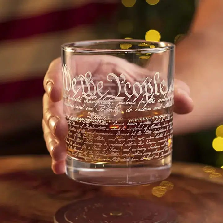 Hand Holding 12oz U.S. Constitution Whisky Glass with detailed engraving, perfect for whiskey lovers and history enthusiasts.