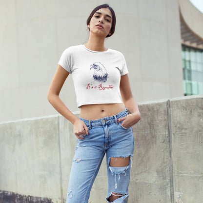 White baby tee crop top with eagle design and "It's A Republic" text worn by lady with black hair.