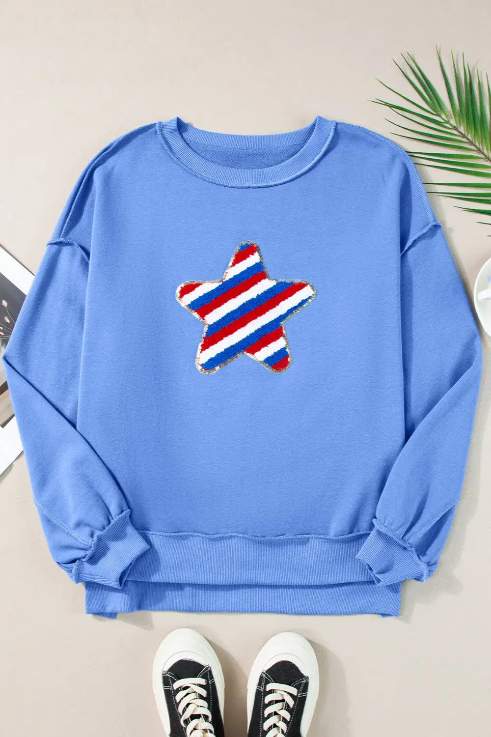 Flat lay Exposed Seam Star Long Sleeve Sweatshirt for women, a stylish patriotic design with cozy fit, perfect for showing American pride