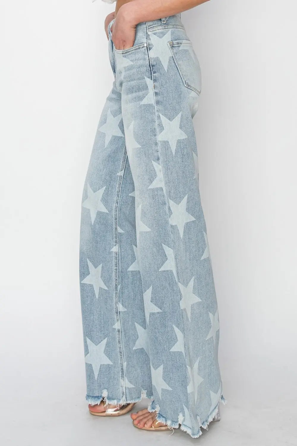 Side view Full Size Raw Hem Star Wide Leg Jeans with trendy star accents, edgy raw hem, and flattering wide-leg fit for bold, stylish looks.