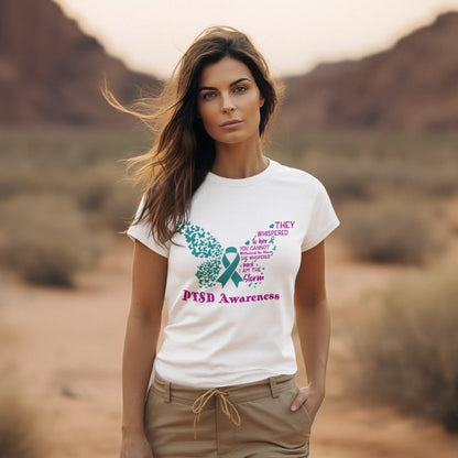 Woman wearing White women's tee with 'She is the Storm' text for PTSD awareness, empowering and supporting mental health advocacy.